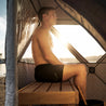 Prism portable sauna tent, inside view with man on bench