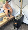 wood-burning sauna stove in use with rocks